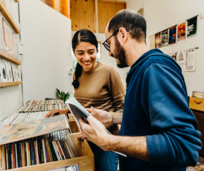 a man and woman browsing through records