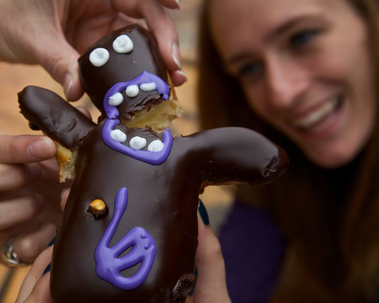 a humanoid-shaped donut being split in two