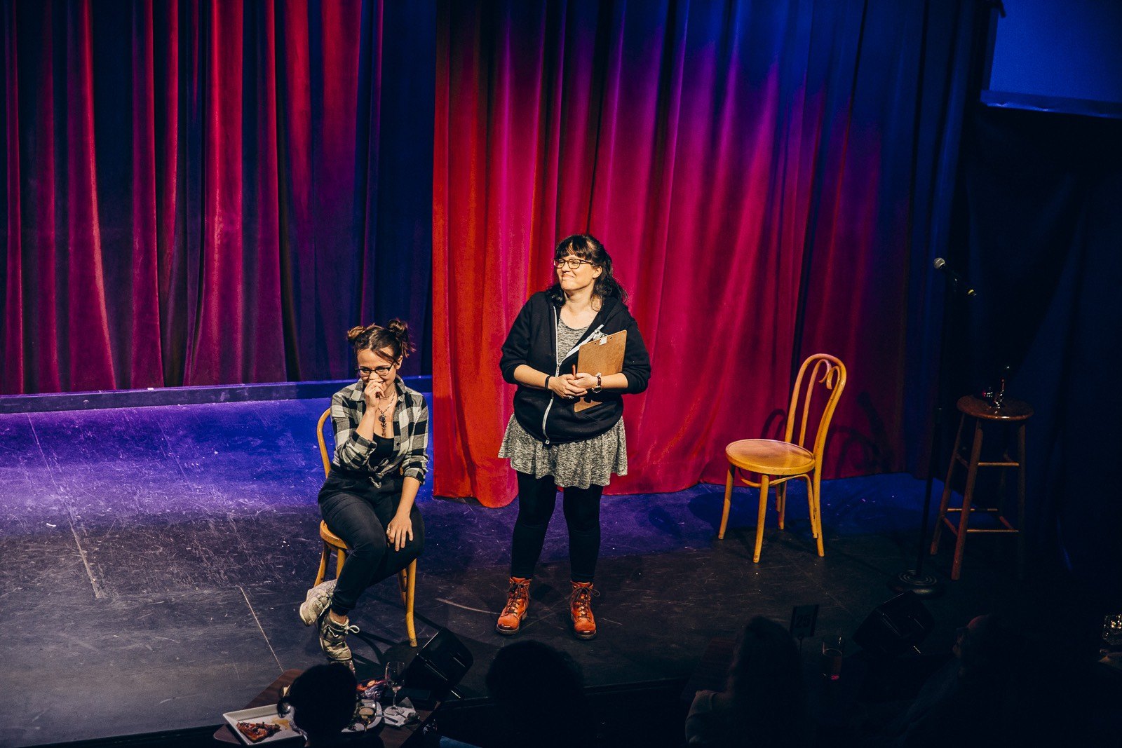 Two female comedians on stage