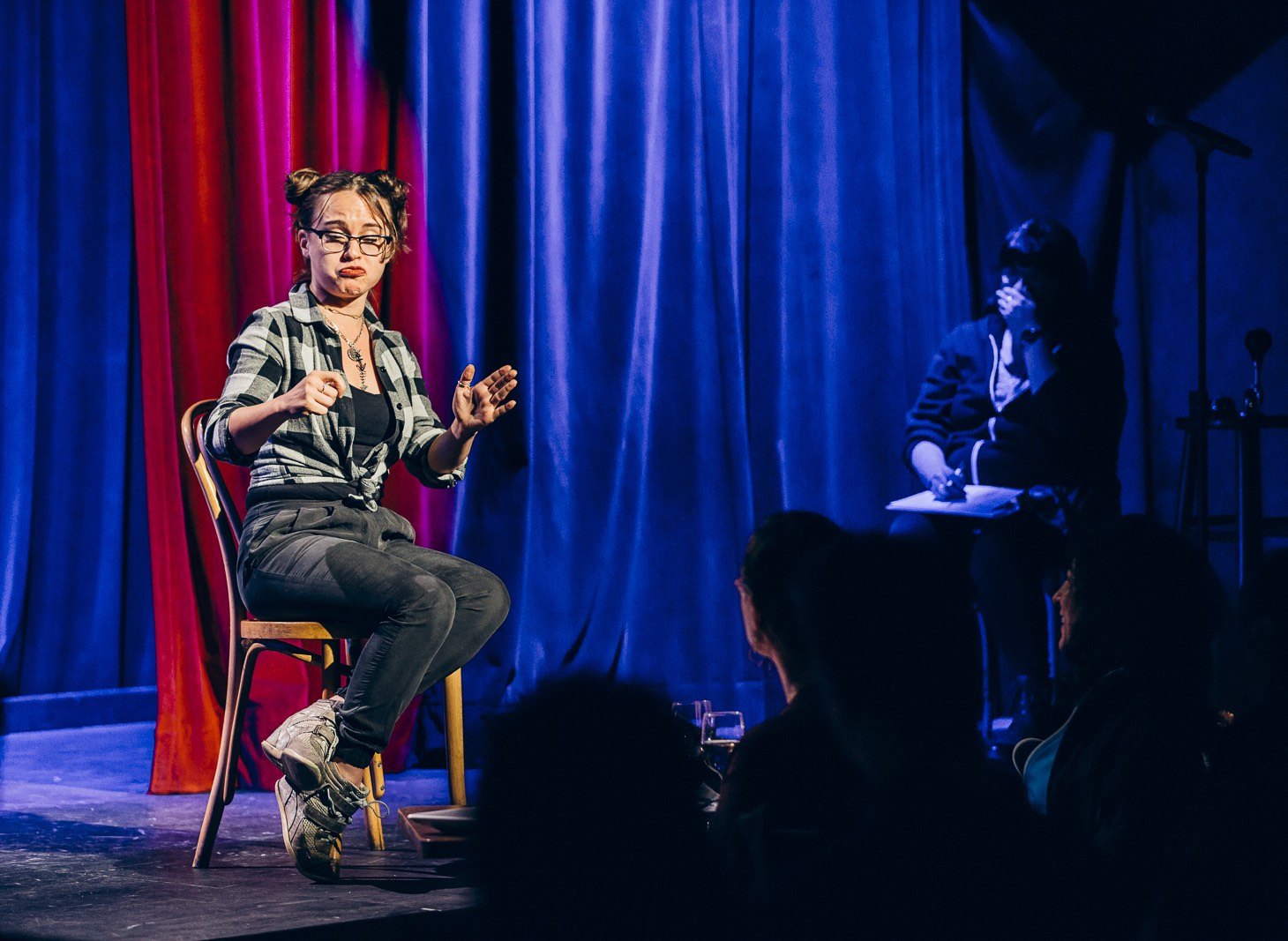 a comedian on stage making a funny face