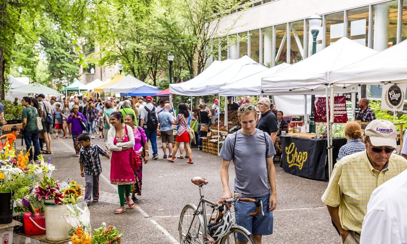 people browsing through an outdoor market