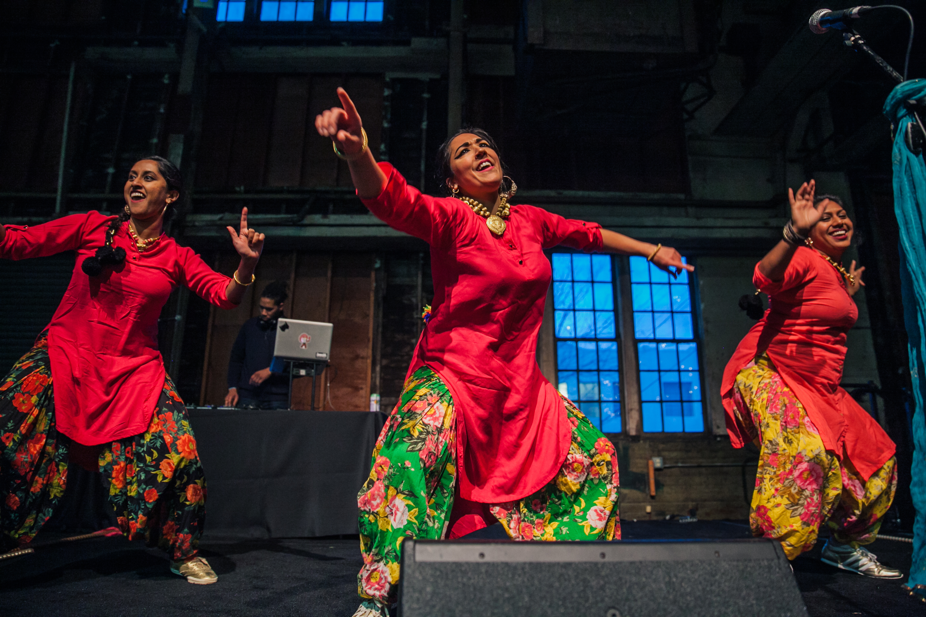 three dancers is bright Indian clothing