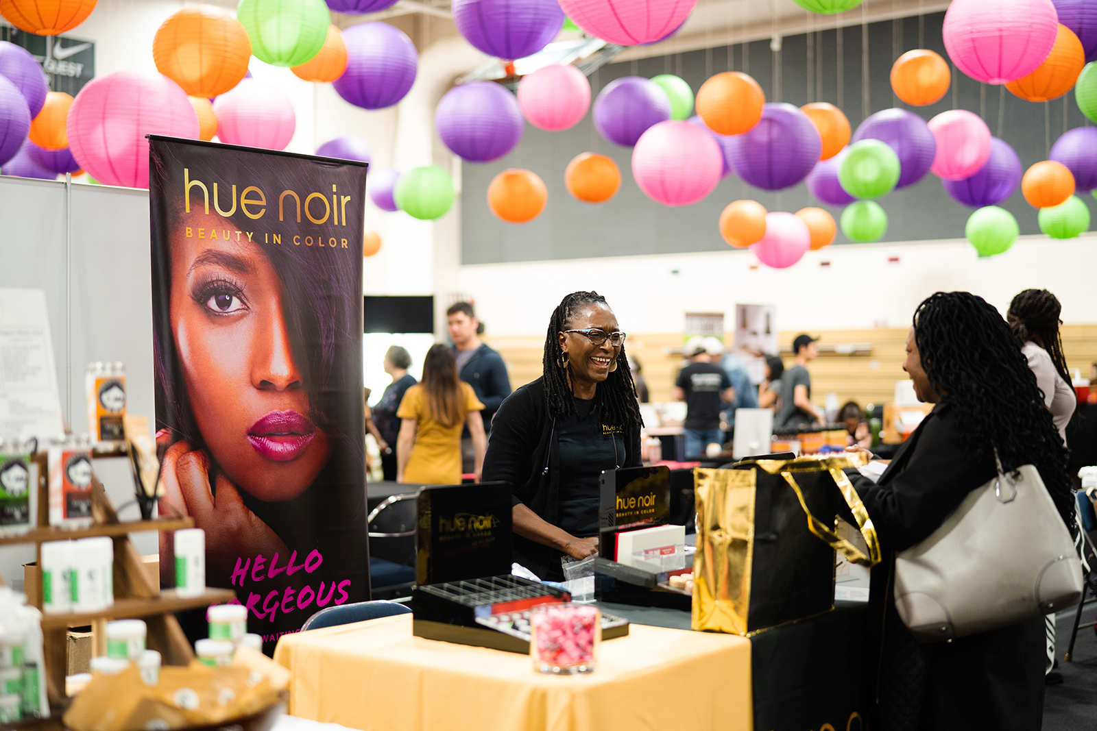 A vendor greets an attendee at My People\'s Market
