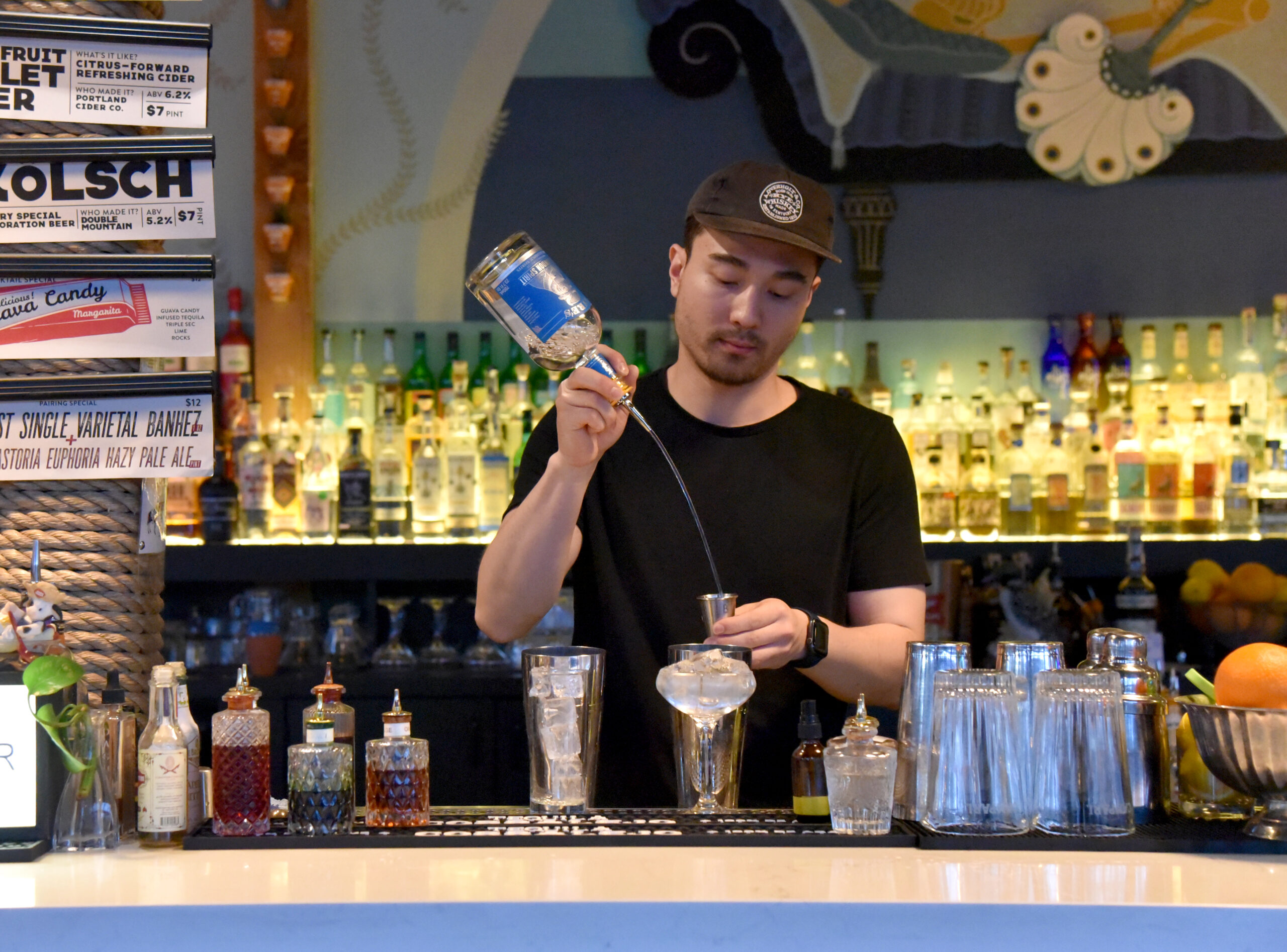 a bartender mixes a cocktail