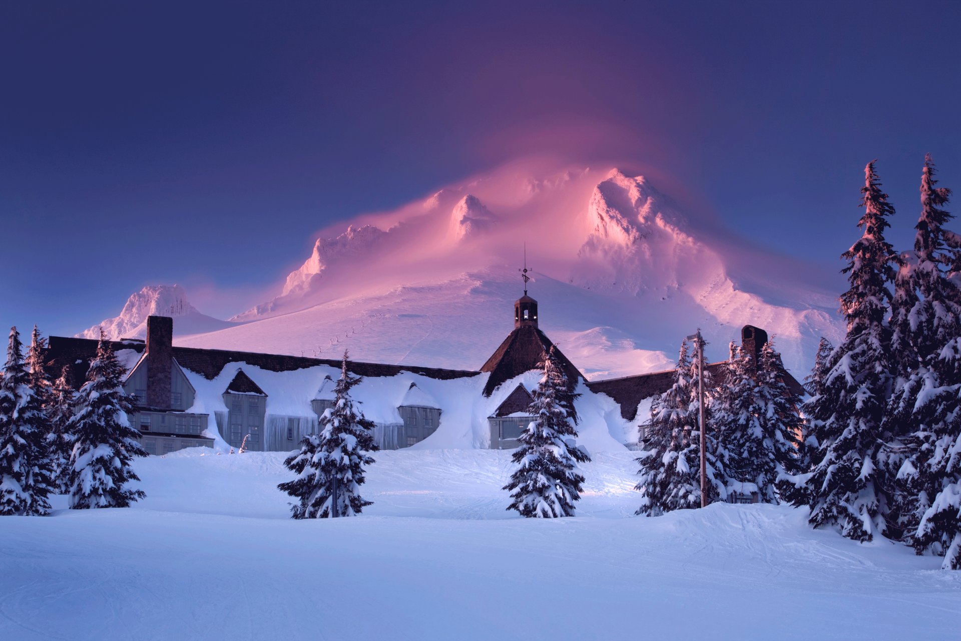 Blue skies appear over snow-covered Mt. Hood and Timberline Lodge.