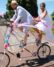 Newlyweds ride a tall tandem bike during Pedalpalooza