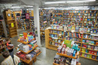 A large room filled with bookshelves and display tables covered with books